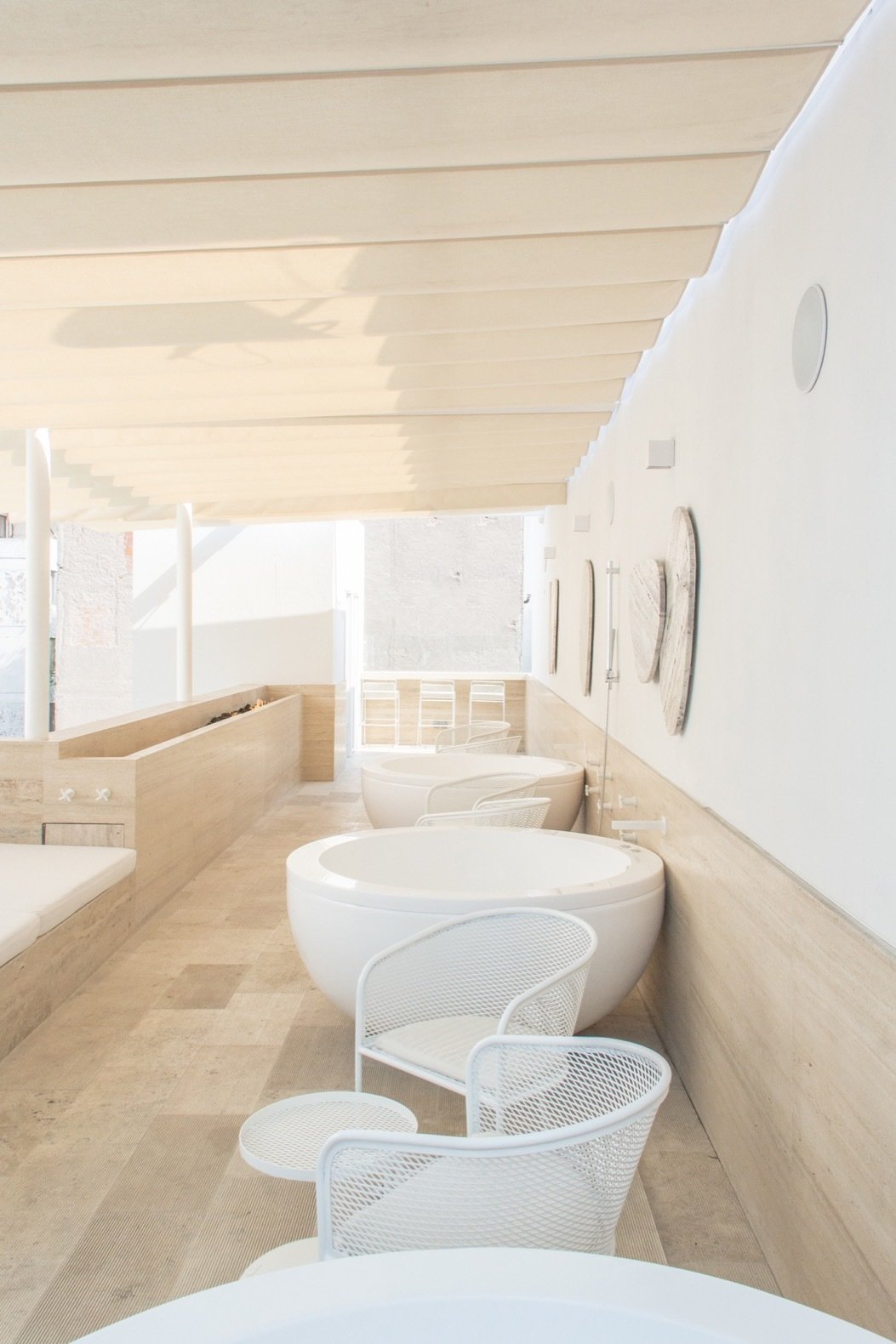 the rooftop deck features four private onsen baths that overlook panoramic city views